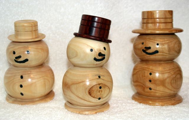 A trio of hand turned snowmen made from sustainable hard and softwoods